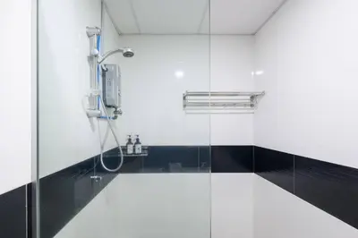 a shower with a glass door in a bathroom at 2R2B/Harmony Sunrise/1~8pax/Gurney/Mansion One in George Town