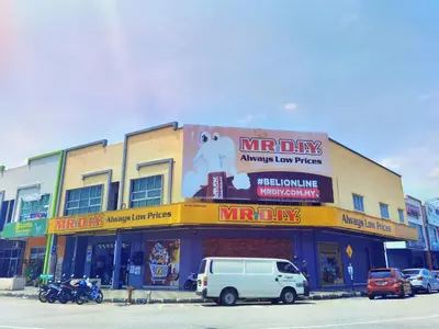a building with a minivan parked in front of it at 1 Day Car Hotel - BG Perdana in Batu Gajah