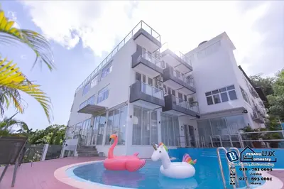 a house with two inflatable flamingos in a swimming pool at Villa w/PrivatePool Golf View Snooker BBQ 10BR in Bayan Lepas