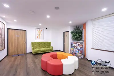 a living room with a green couch and a red stool at Villa w/PrivatePool Golf View Snooker BBQ 10BR in Bayan Lepas
