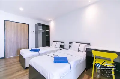 a bedroom with two beds with blue towels on them at Villa w/PrivatePool Golf View Snooker BBQ 10BR in Bayan Lepas