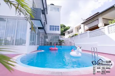 a swimming pool with two inflatables in a building at Villa w/PrivatePool Golf View Snooker BBQ 10BR in Bayan Lepas