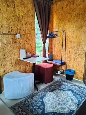 a room with a table and two chairs and a table and a rug at D'RUMAH BONDA RIVER VIEW Kuala Kangsar in Kampong Senawar